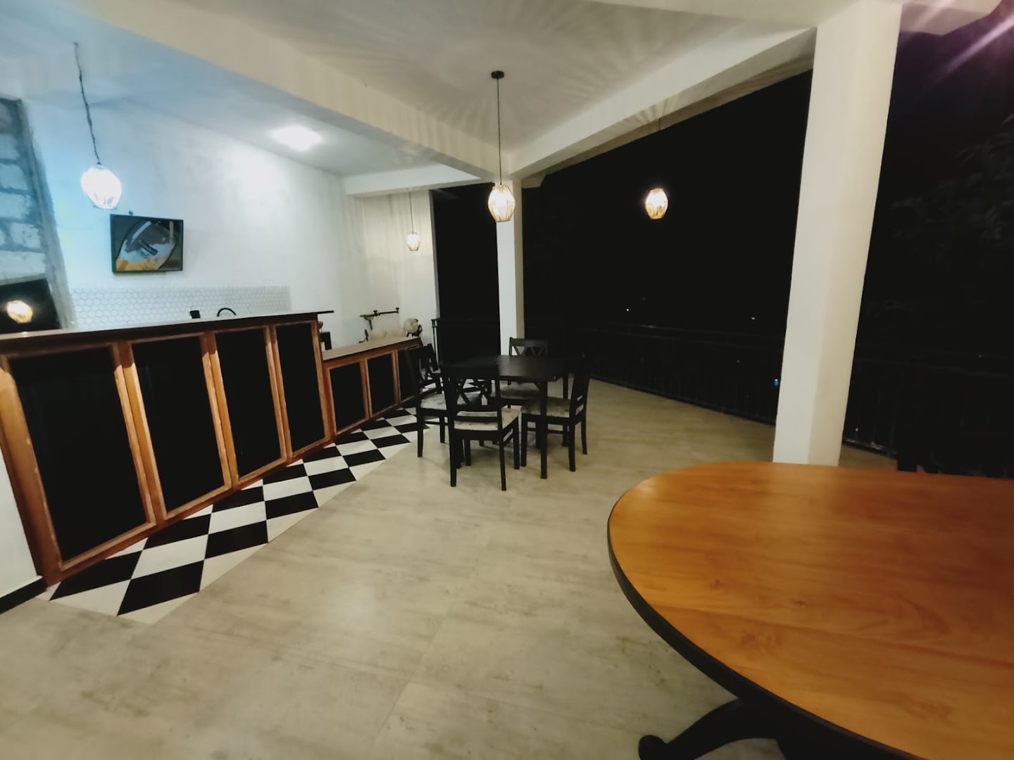 Open dining space with pendant lights and timber tables