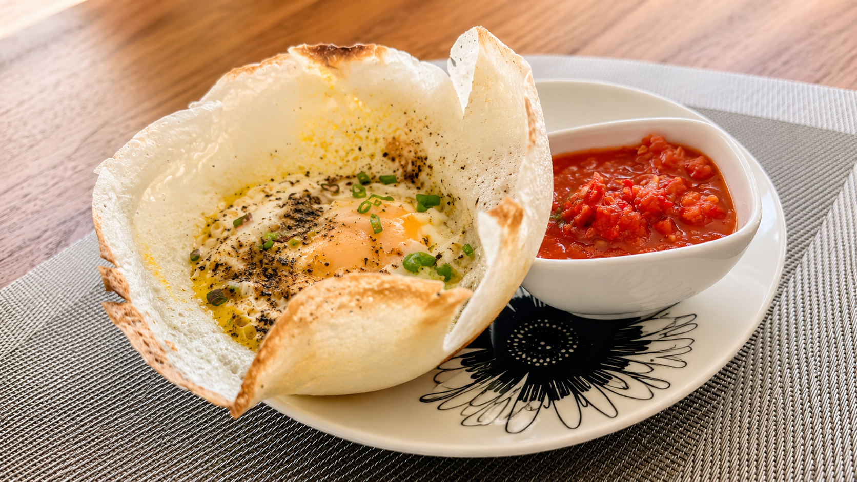 Breakfast plate with an egg hopper and bright red sambol